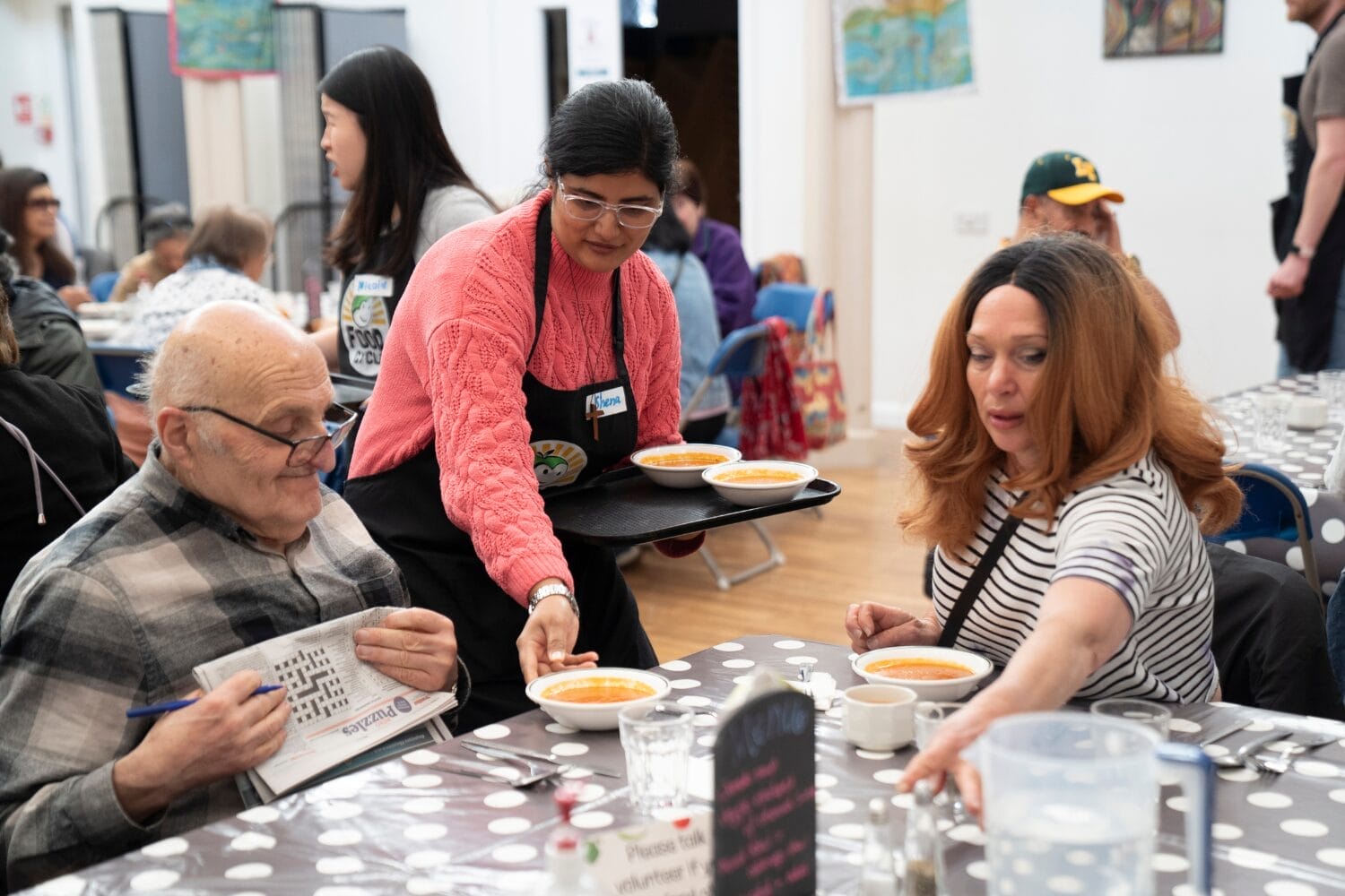 Guests being served food at FoodCycle community meal