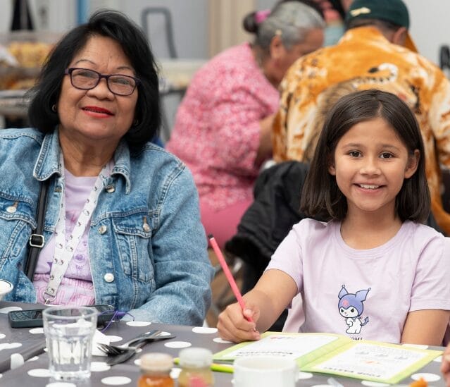 Family smiling at FoodCycle community meal