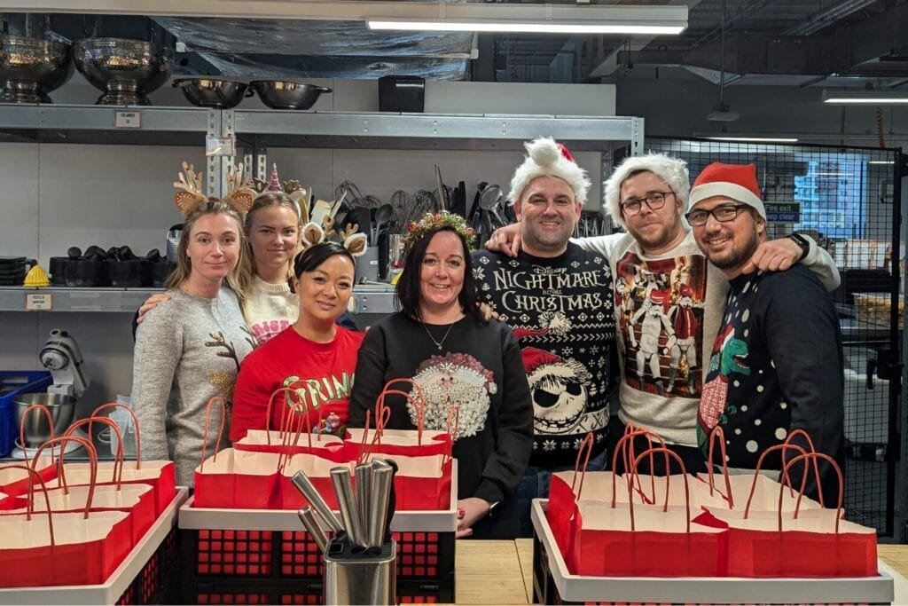 Team of people in Christmas Jumpers at festive Food Invention Challenge