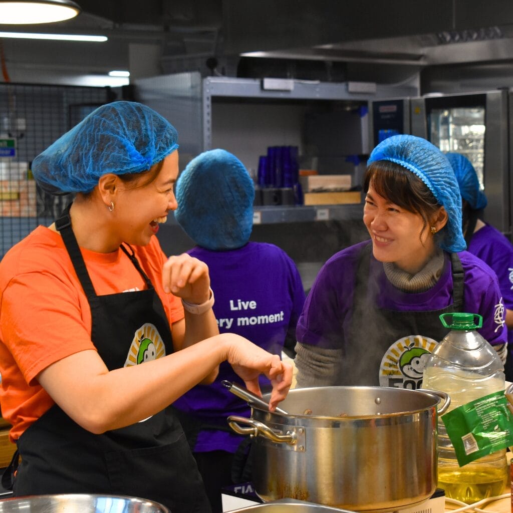 Two people cooking in a kitchen